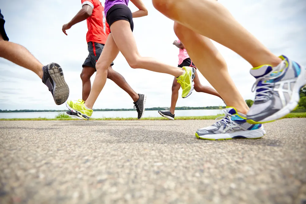 Low side view of athletes running on a track
